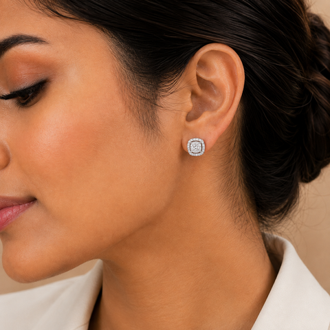 A close-up side profile of a woman wearing a small square stud earring with a halo setting. The earring features a silver-toned metal border with small clear stones, which do not contribute to the color mapping according to the schema rules.